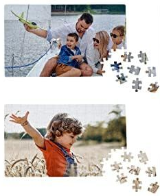 A mostly complete jigsaw puzzle with a man, woman, and two children on a sailboat, and a mostly complete jigsaw puzzle with a young boy on the beach.