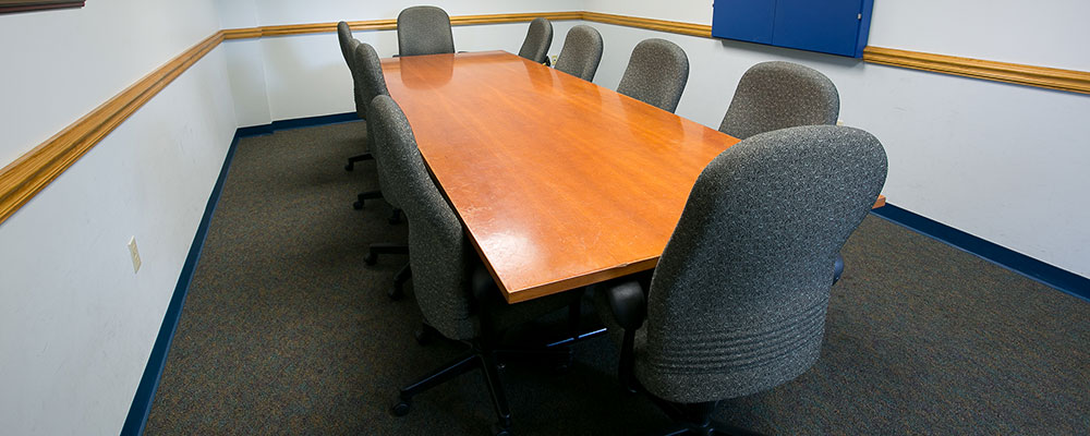 Conference room with long table and 10 chairs