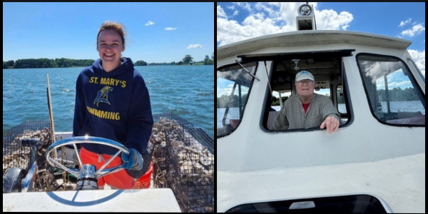 A woman stands at the wheel of a boat surrounded by oyster traps. A man looks out the front window of a boat.