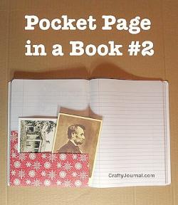 An open lined notebook with a pink pocket with old photos sticking out of it