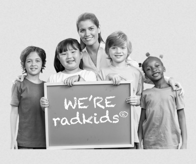 A woman and four children stand holding a chalkboard reading We're radkids